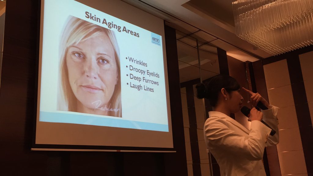 Aimin physician giving talk on skin aging and TCM treatments