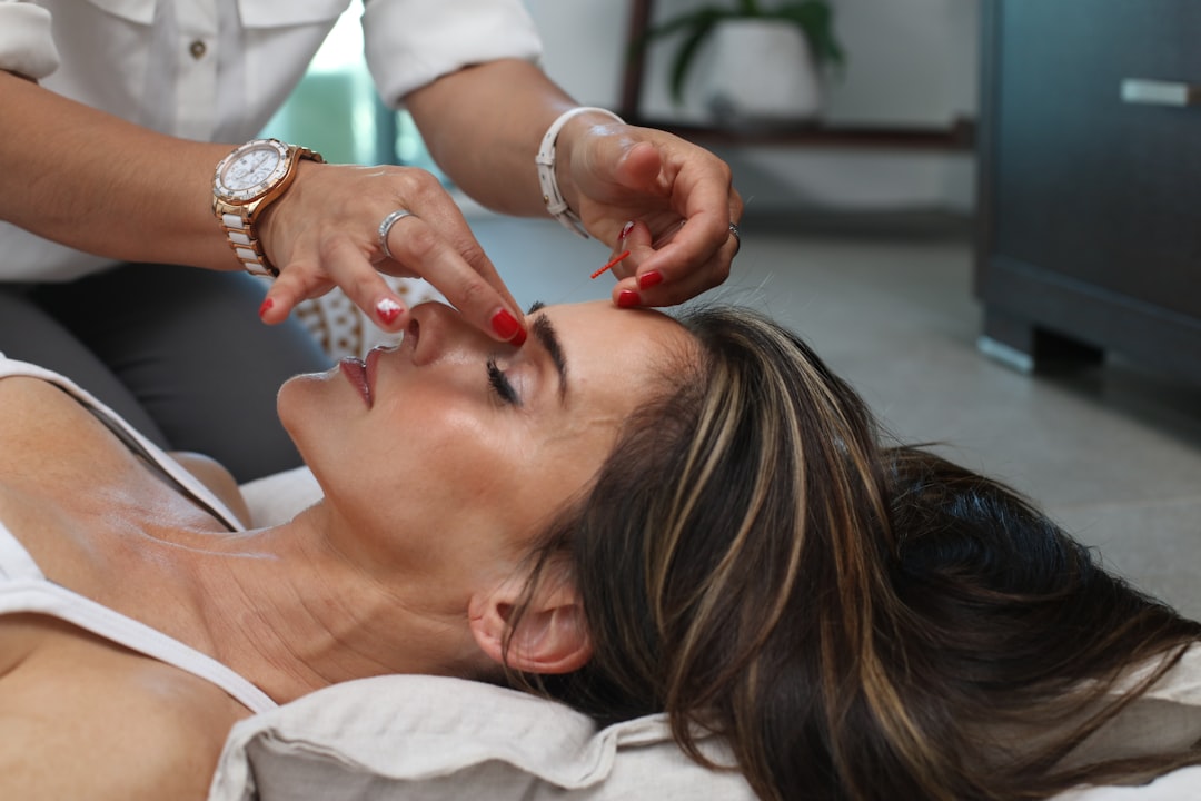 Woman enjoying relaxing Bojin eye therapy session